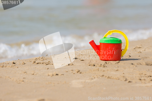 Image of Children head left on the shore of the beach near the water