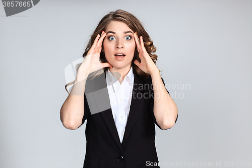 Image of Portrait of young woman with shocked facial expression