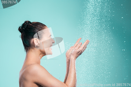 Image of Woman enjoying water in the shower under a jet