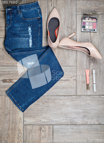 Image of Flat lay photo of girl\'s jeans and accessories