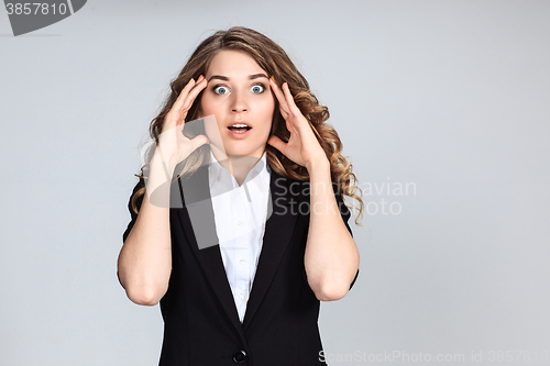 Image of Portrait of young woman with shocked facial expression