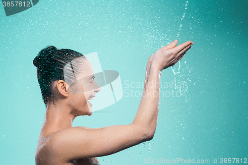 Image of Woman enjoying water in the shower under a jet