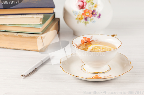 Image of Tea with  lemon and books on the table