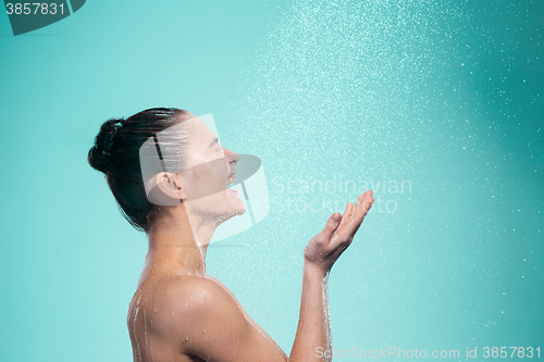 Image of Woman enjoying water in the shower under a jet