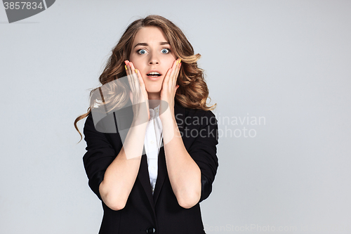 Image of Portrait of young woman with shocked facial expression