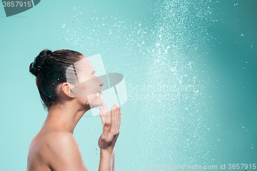 Image of Woman enjoying water in the shower under a jet