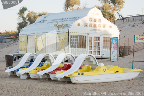 Image of Anapa, Russia - September 21, 2015: Water catamarans are on the sand in front of a cafe on the beach in the early morning