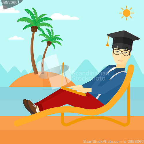 Image of Graduate lying on chaise lounge with laptop.