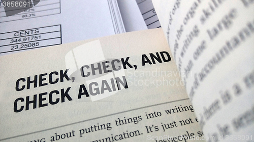 Image of Check again word on the book 