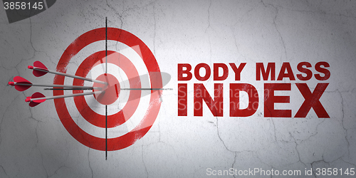 Image of Health concept: target and Body Mass Index on wall background