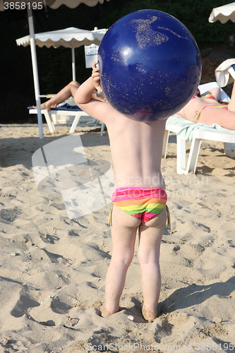 Image of Baby girl and her big blue ball