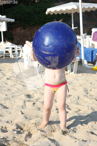 Image of Baby girl and her big blue ball