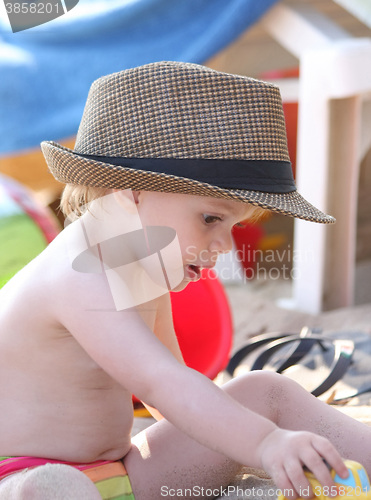 Image of Baby girl playing on the beach