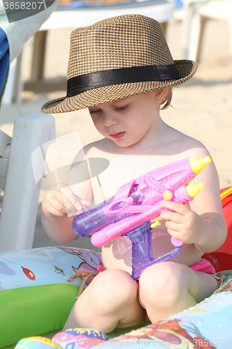 Image of Baby girl playing on the beach