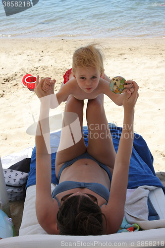 Image of Mother and her baby girl on the beach