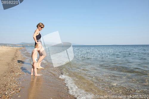 Image of Grandmother and her granddaughter on the beach