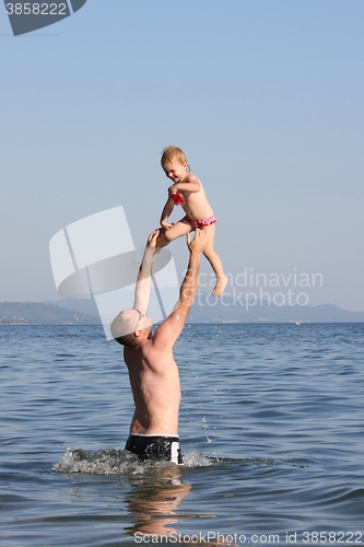 Image of Father playing with his baby girl