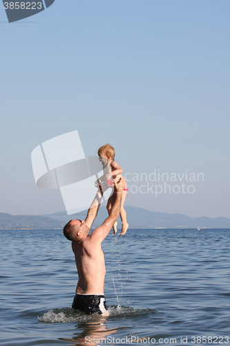 Image of Father playing with his baby girl