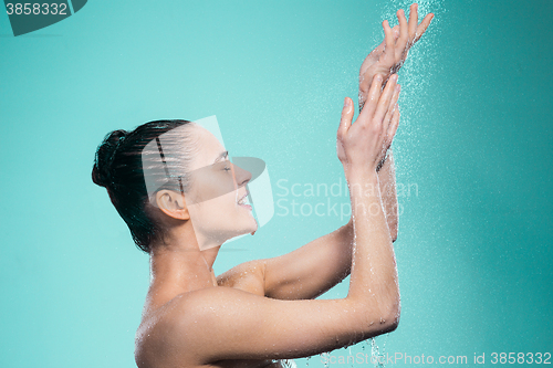 Image of Woman enjoying water in the shower under a jet