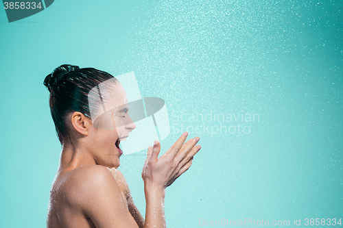 Image of Woman enjoying water in the shower under a jet