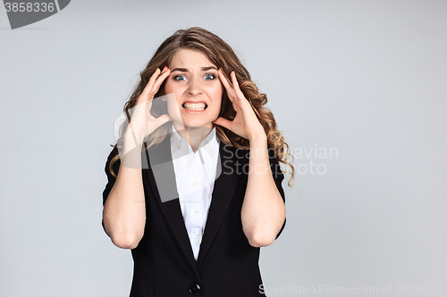 Image of Portrait of young woman with shocked facial expression