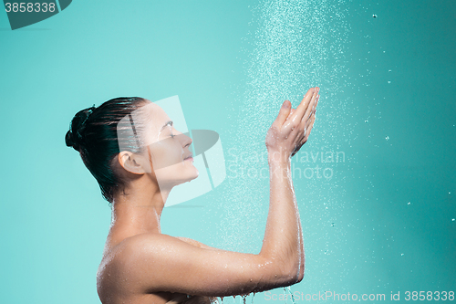 Image of Woman enjoying water in the shower under a jet