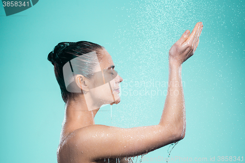 Image of Woman enjoying water in the shower under a jet