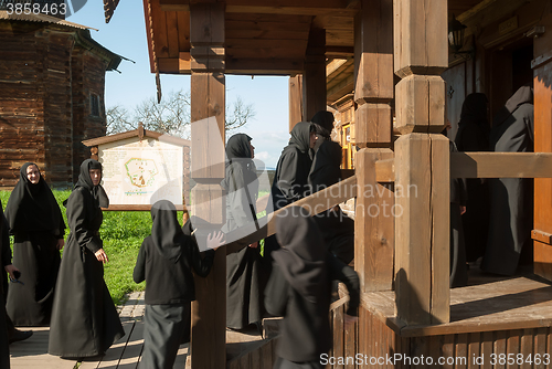 Image of Novices of convent visit museum in Suzdal. Russia