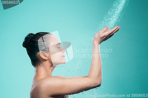 Image of Woman enjoying water in the shower under a jet