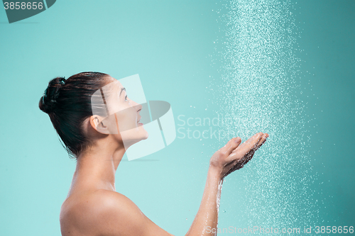 Image of Woman enjoying water in the shower under a jet