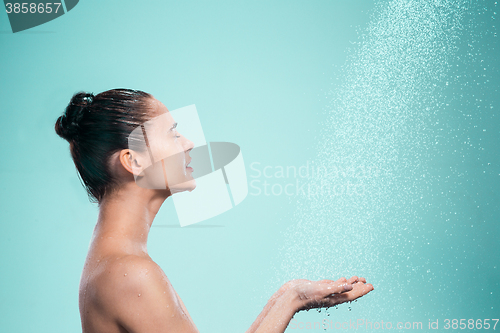 Image of Woman enjoying water in the shower under a jet