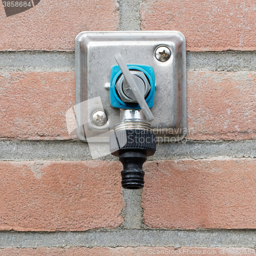 Image of Faucet in a brick wall