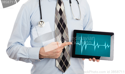 Image of Doctor holding tablet - Heartbeat graph