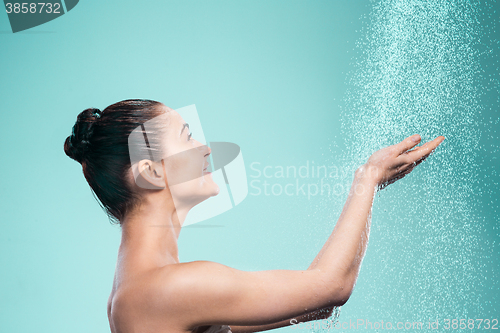 Image of Woman enjoying water in the shower under a jet