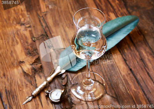 Image of Grappa in a small glas on old wooden table