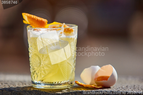 Image of whiskey sour in the sunlight.