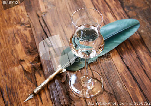 Image of Grappa in a small glas on old wooden table
