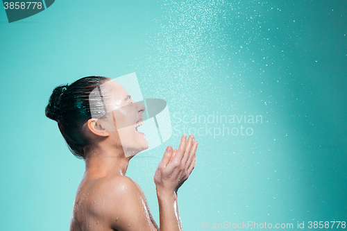 Image of Woman enjoying water in the shower under a jet