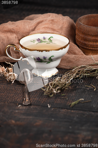 Image of Tea with  lemon and dried flowers on the table