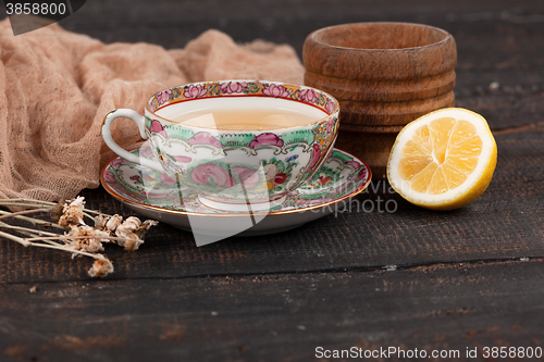Image of Tea with  lemon and primroses on the table
