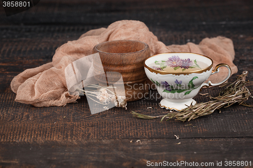 Image of Tea with  lemon and dried flowers on the table