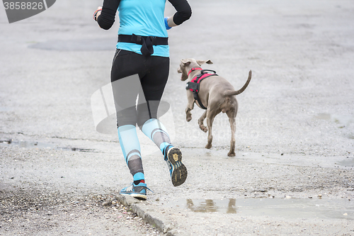 Image of Woman running with dog