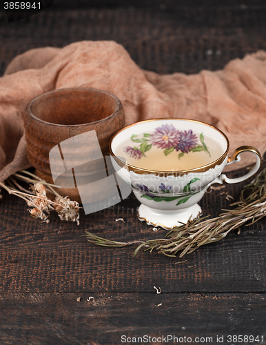 Image of Tea with  lemon and dried flowers on the table