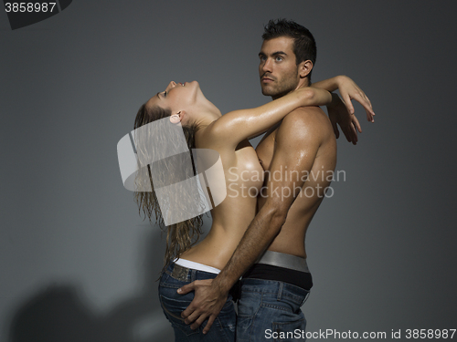 Image of erotic scene of a sexy couple in jeans having sex