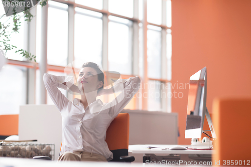 Image of happy young business woman relaxing and geting insiration