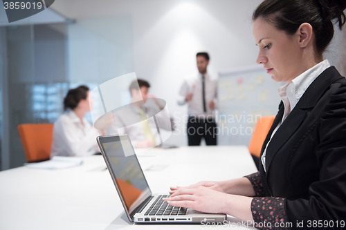 Image of young business woman on meeting  using laptop computer