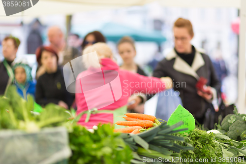 Image of People buying vegetable at local food market. 