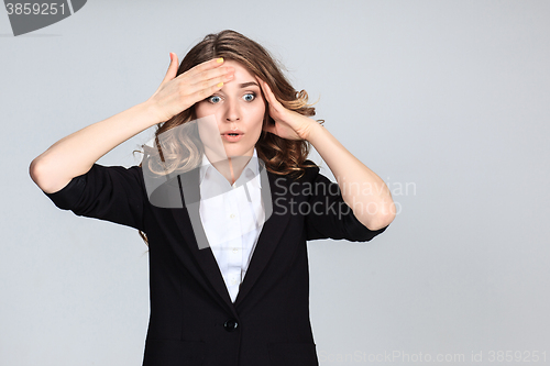 Image of Portrait of young woman with shocked facial expression