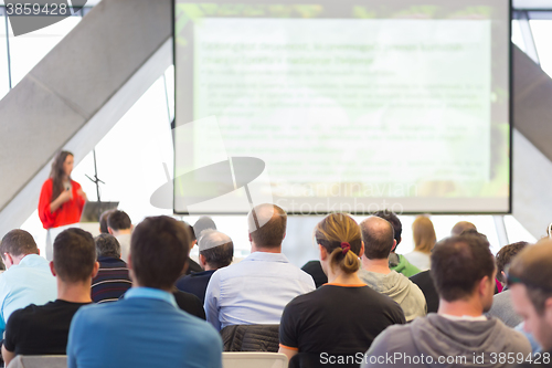 Image of Female speeker having talk at public event.