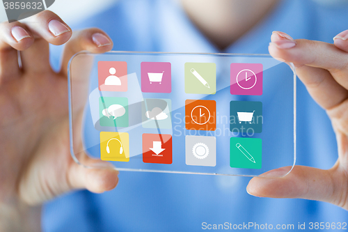 Image of close up of woman with transparent smartphone